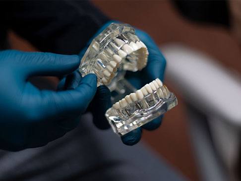 Dental lab technician crafting dental restoration