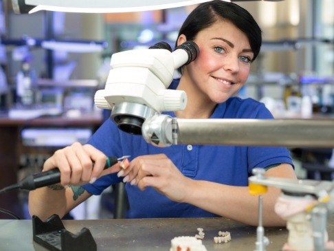 Dental team member looking at dental restoration