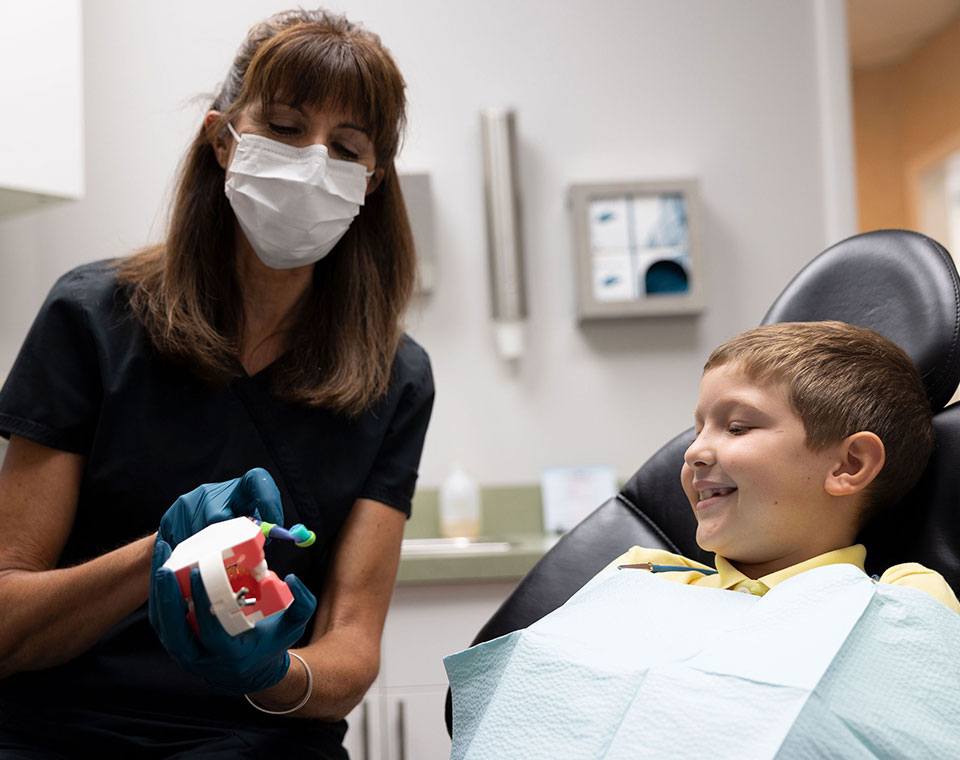 Woman giving thumbs up after preventive dentistry treatment