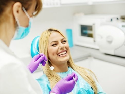 Woman smiling during dental checkup and teeth cleaning visit