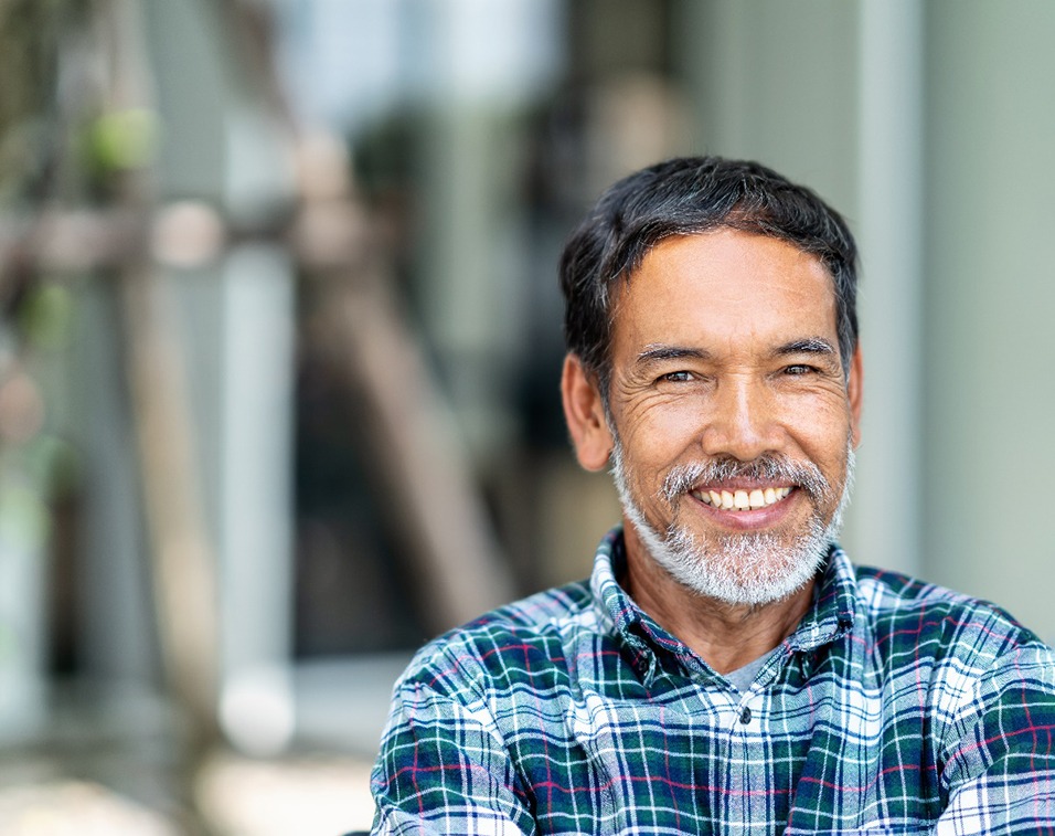 mature man smiling with dental crowns in Ledgewood 