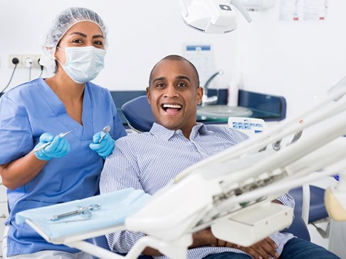 Three dental crowns on dark reflective surface