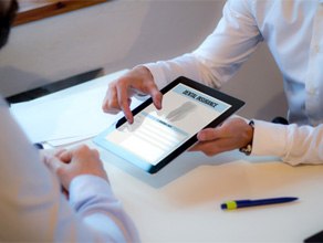 Dentist showing patient dental insurance form on tablet