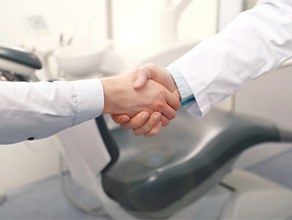Patient shaking hands with emergency dentist in Ledgewood, NJ