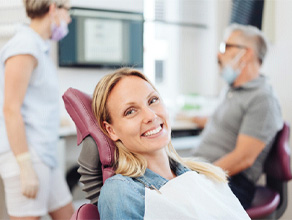 Woman smiling at a dentist in Ledgewood