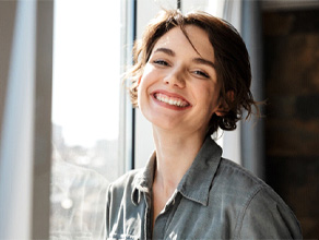 Woman smiling with dental implants in Ledgewood