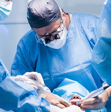 Dentists performing a dental implant surgery