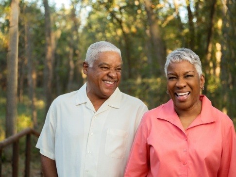 Man and woman enjoying the benefits of dental implants