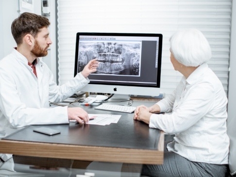 Dentist and patient discussing the cost of dental implants