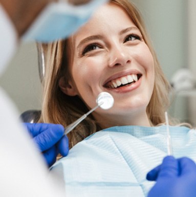 : A woman receiving a dental checkup from her dentist