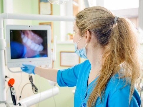 Dentist looking at images captured by intraoral cameras
