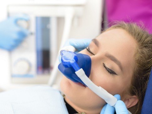 Relaxing dental patient during nitrous oxide sedation dentistry treatment