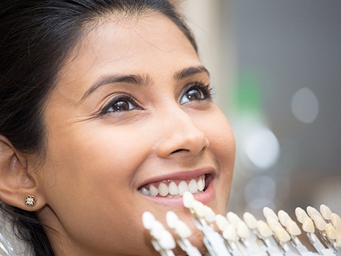 woman choosing shade of veneers