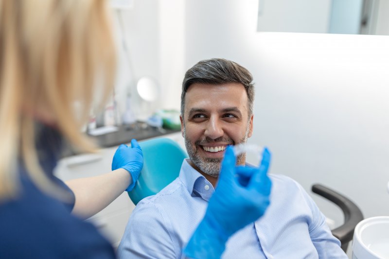 A dentist and her patient talking at his dental checkup